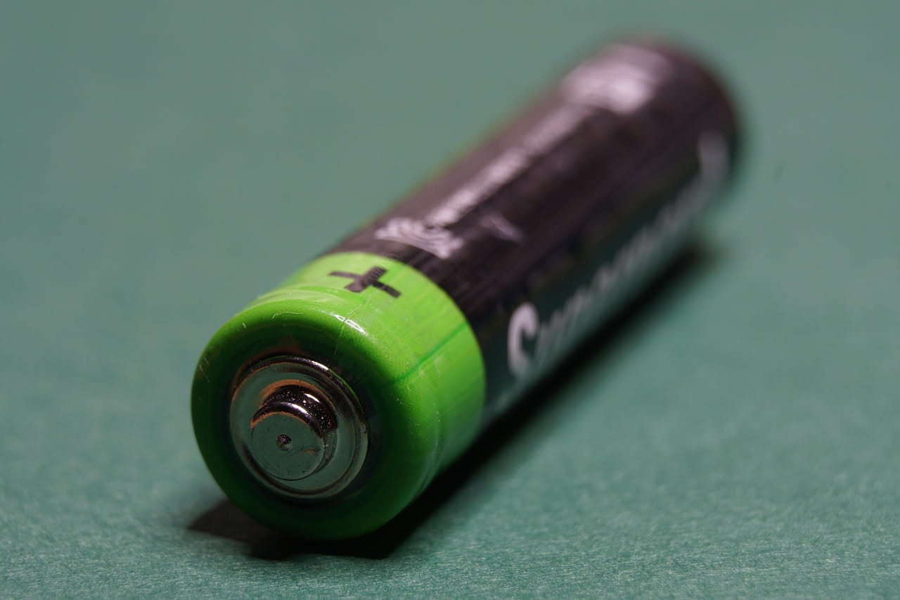 Sezione trasversale di una batteria al litio che mostra l anodo rosso, il catodo blu, l elettrolita giallo e il separatore trasparente con ioni in movimento